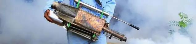 Fumigation technician using a fogger for deep pest treatment in Fort Lauderdale, FL